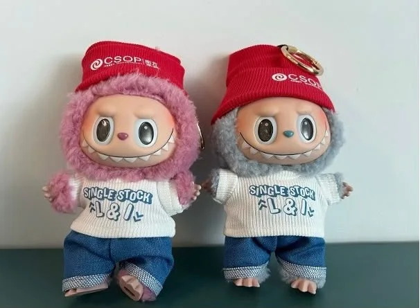 Two character gifts wearing CSOP branded hats and clothing