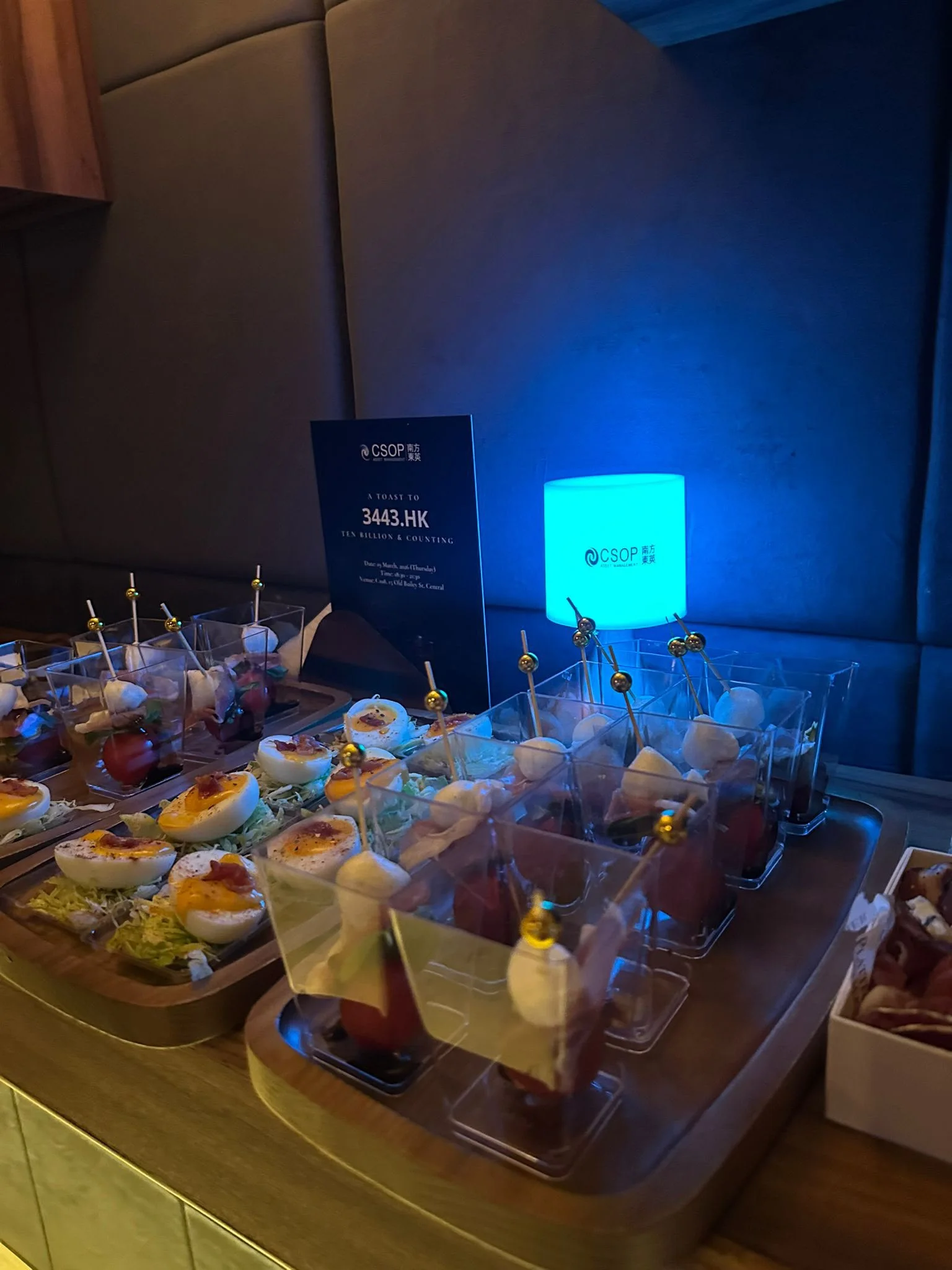 Canapés presented with a blue CSOP branded light at an evening reception