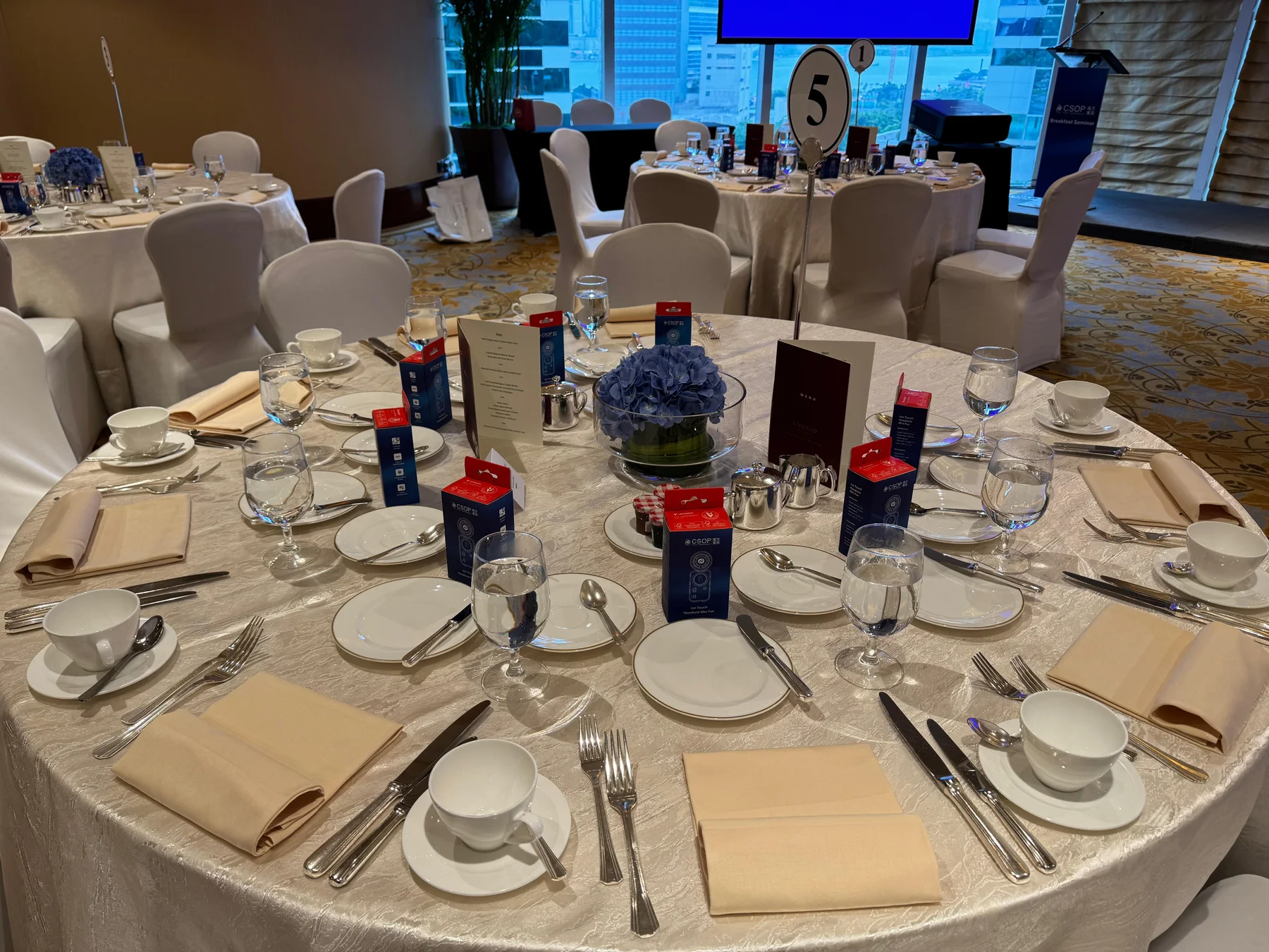 Seminar table setting with catering arrangements and guest gifts