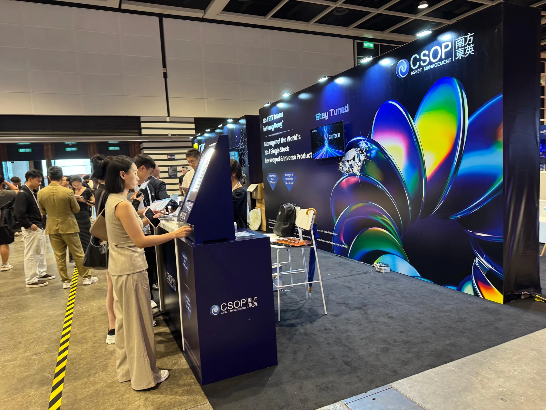 Visitors engaging with a branded CSOP exhibition booth