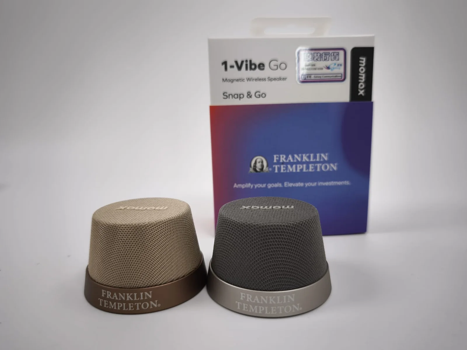 Two Franklin Templeton branded wireless speakers with gift packaging